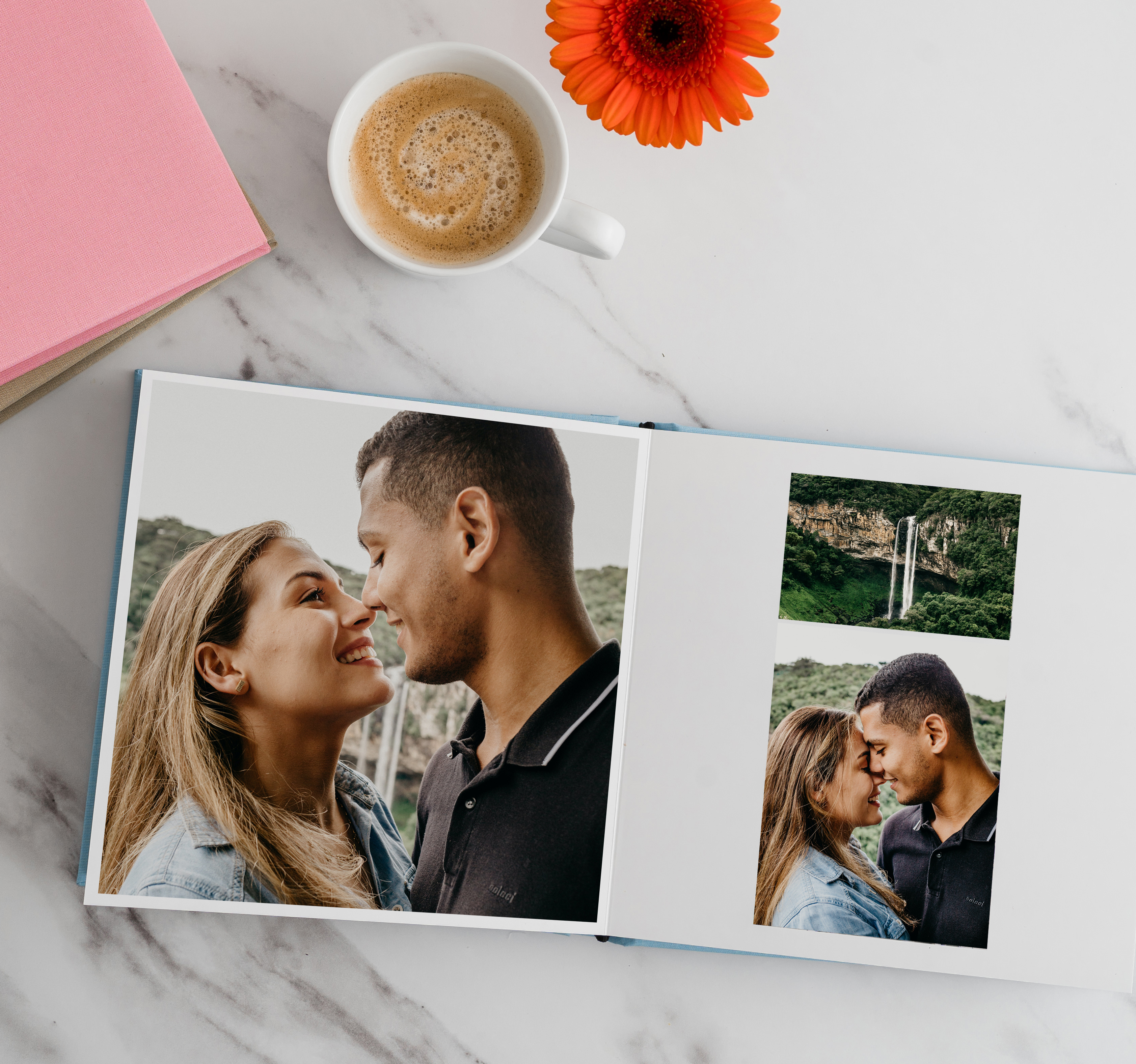 Photo book showing engagement photos of couple next to water fall.
