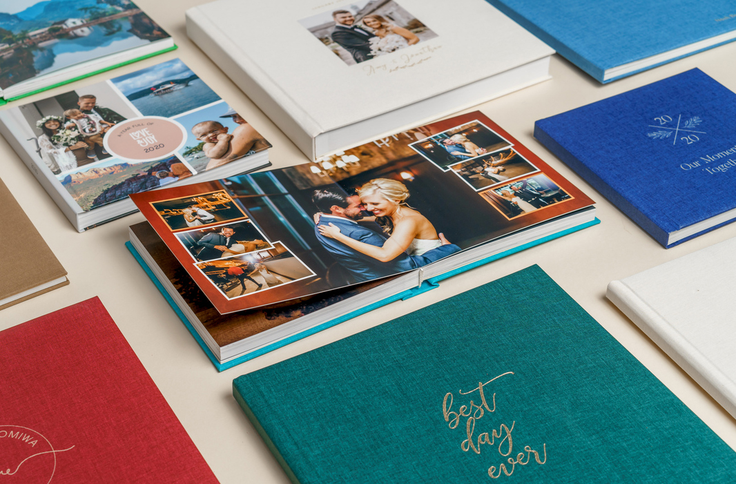 Professional photo album samples on wooden table