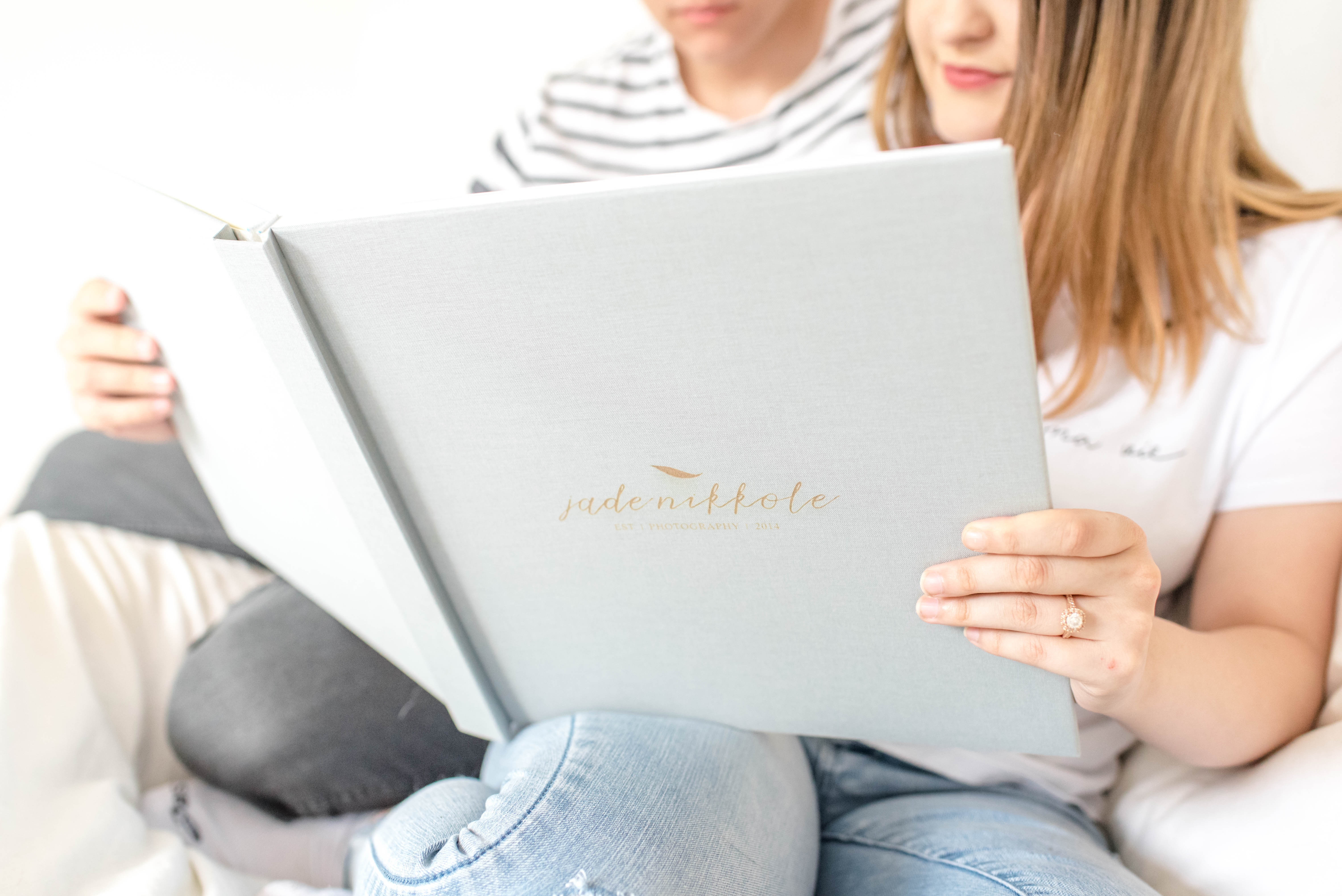 Couple viewing a professional photo book designed for wedding photographers