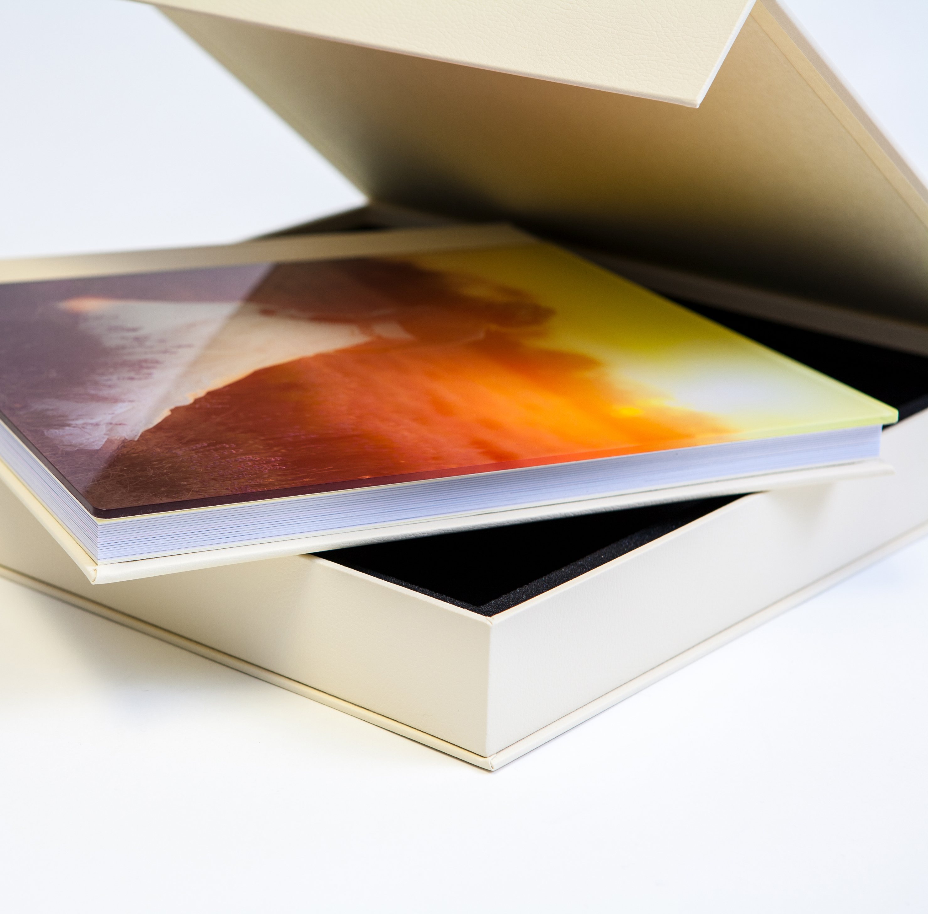 Glass photo album laying on presentation box
