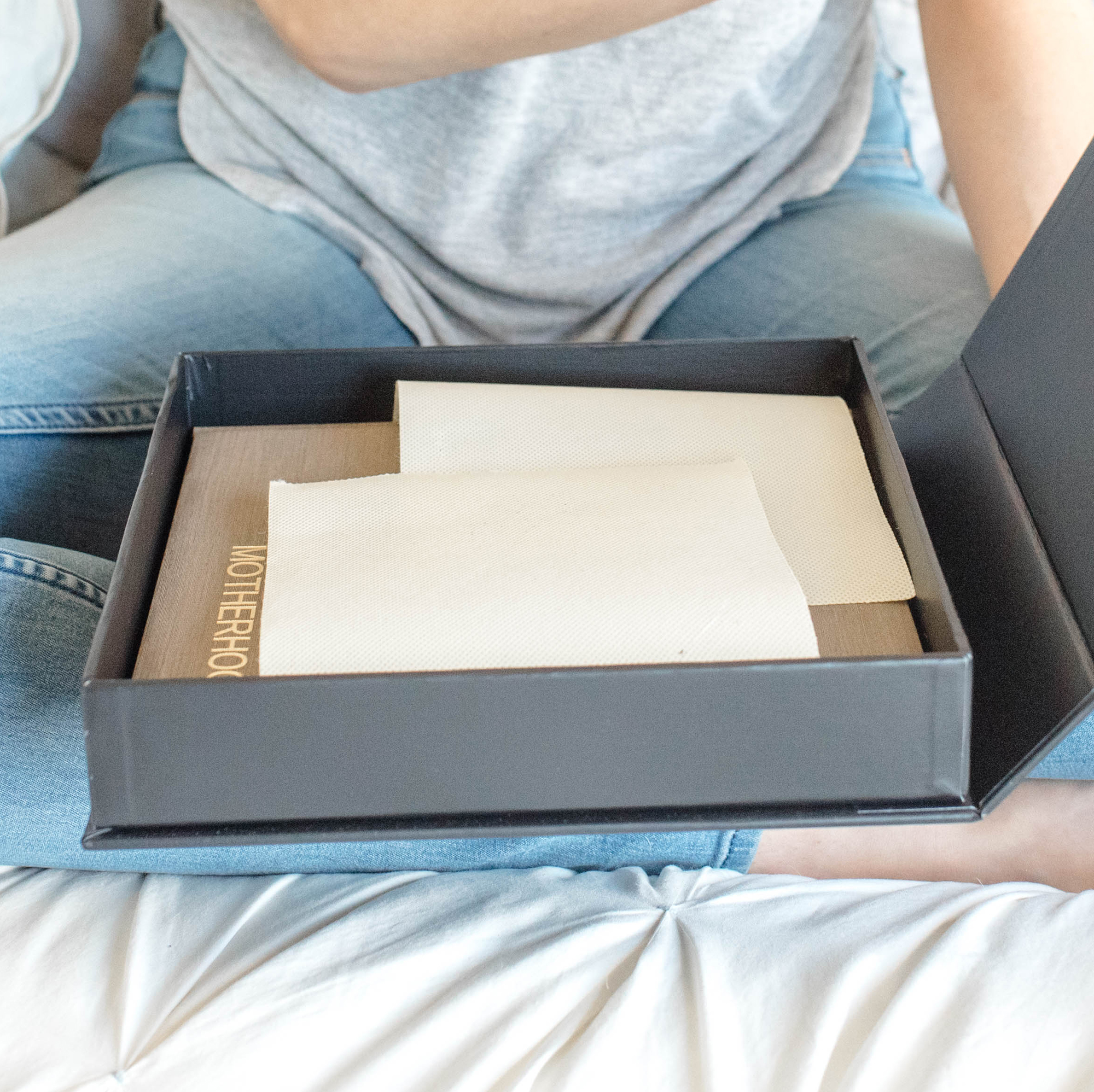 Women viewing photo book in a gift box