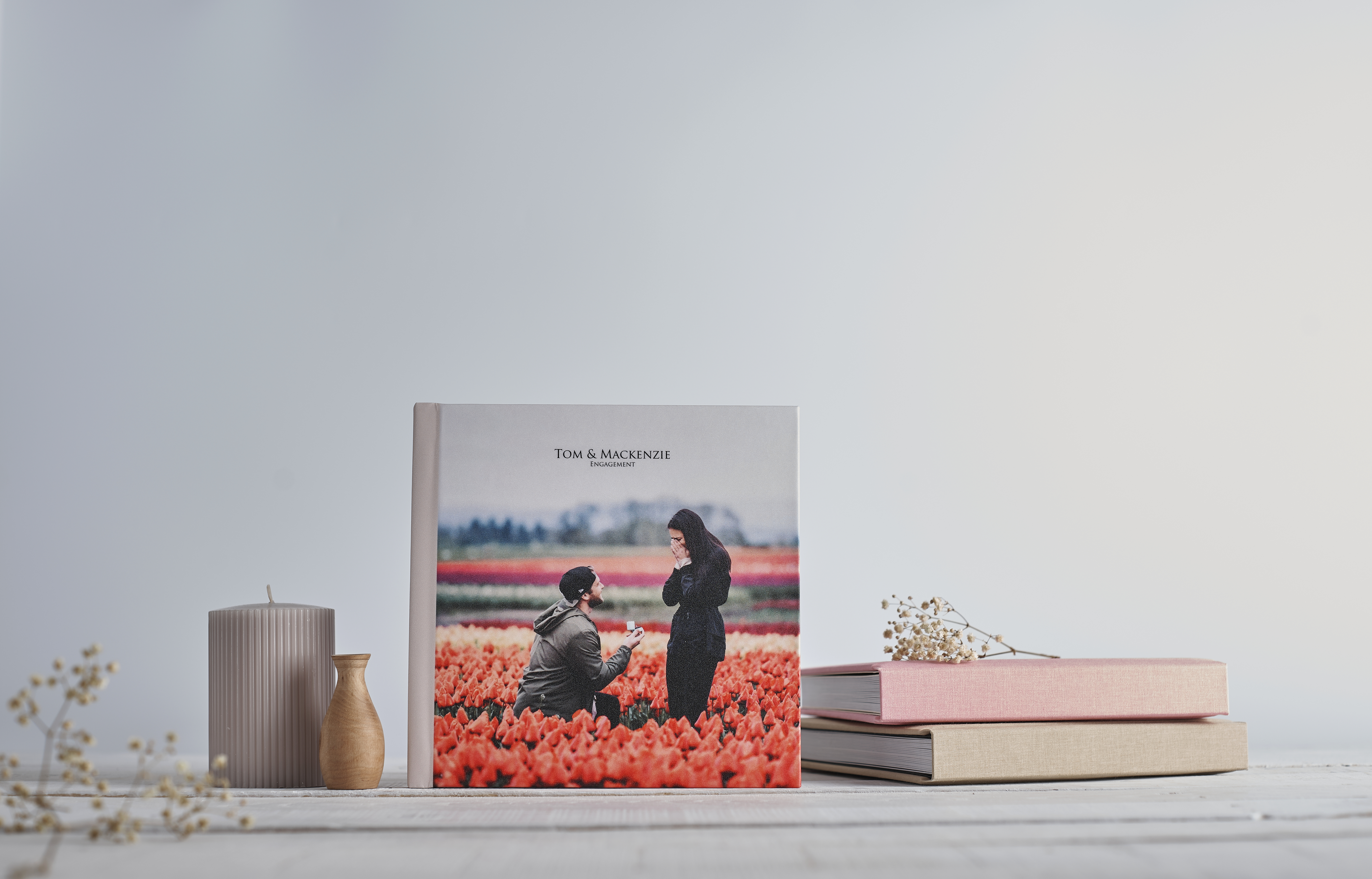 Engagement photo book cover examples on table