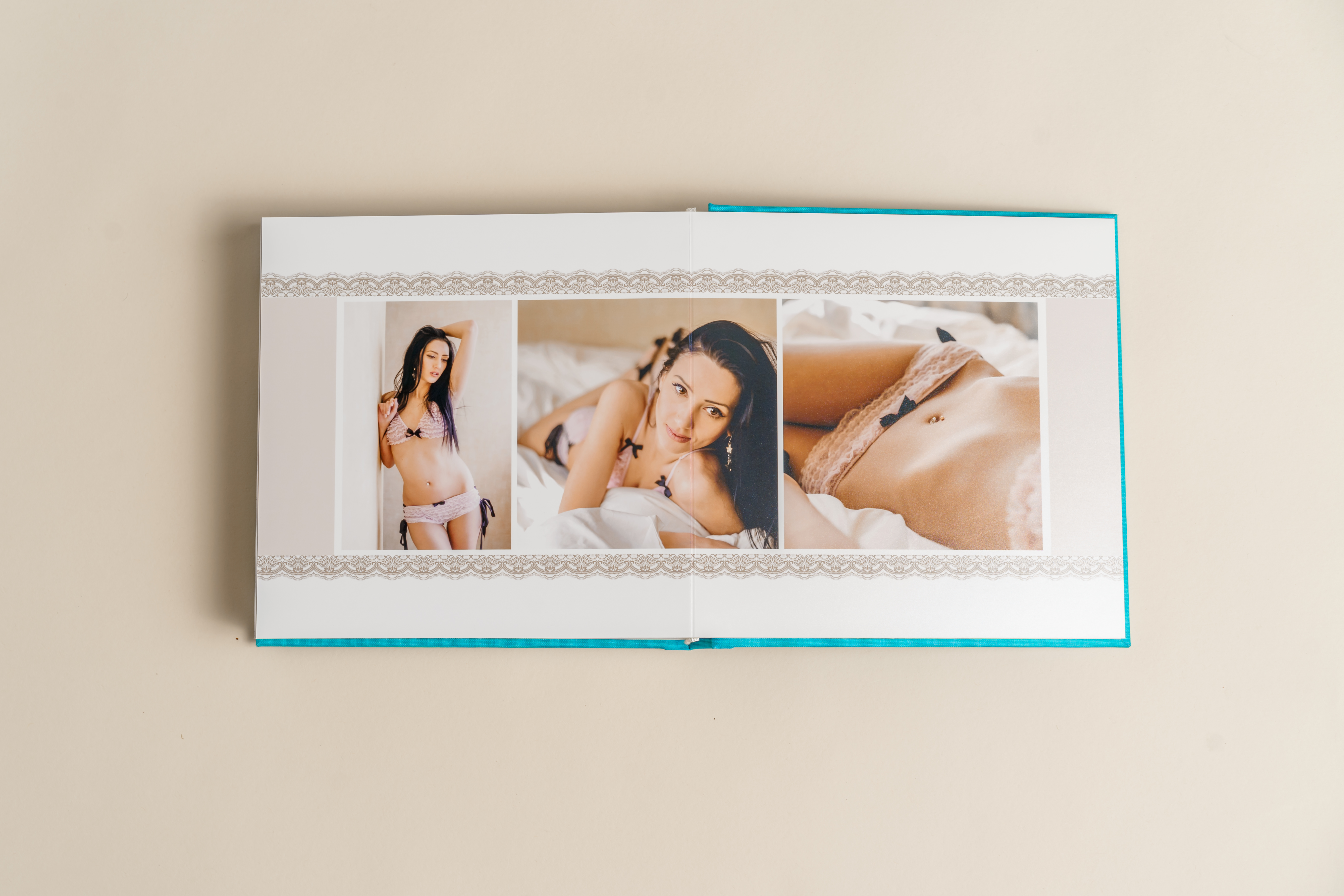 A premium boudoir photo book laying on a carpet