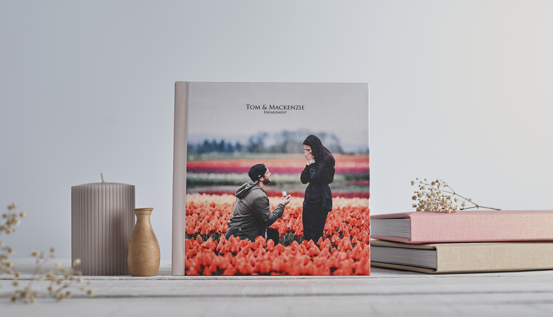Photo album cover showing engaged couple proposing.
