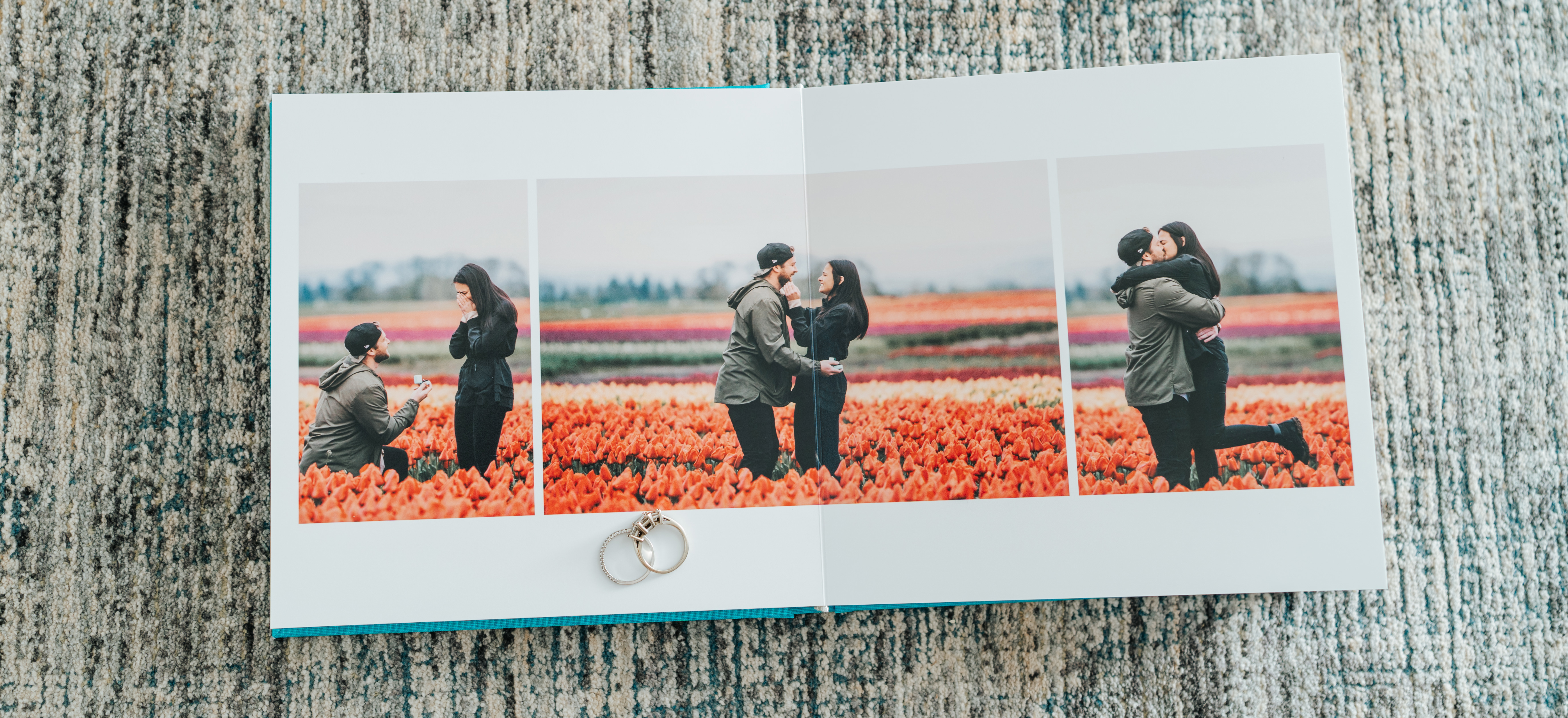 Premium engagement photo album laying open with rings on top