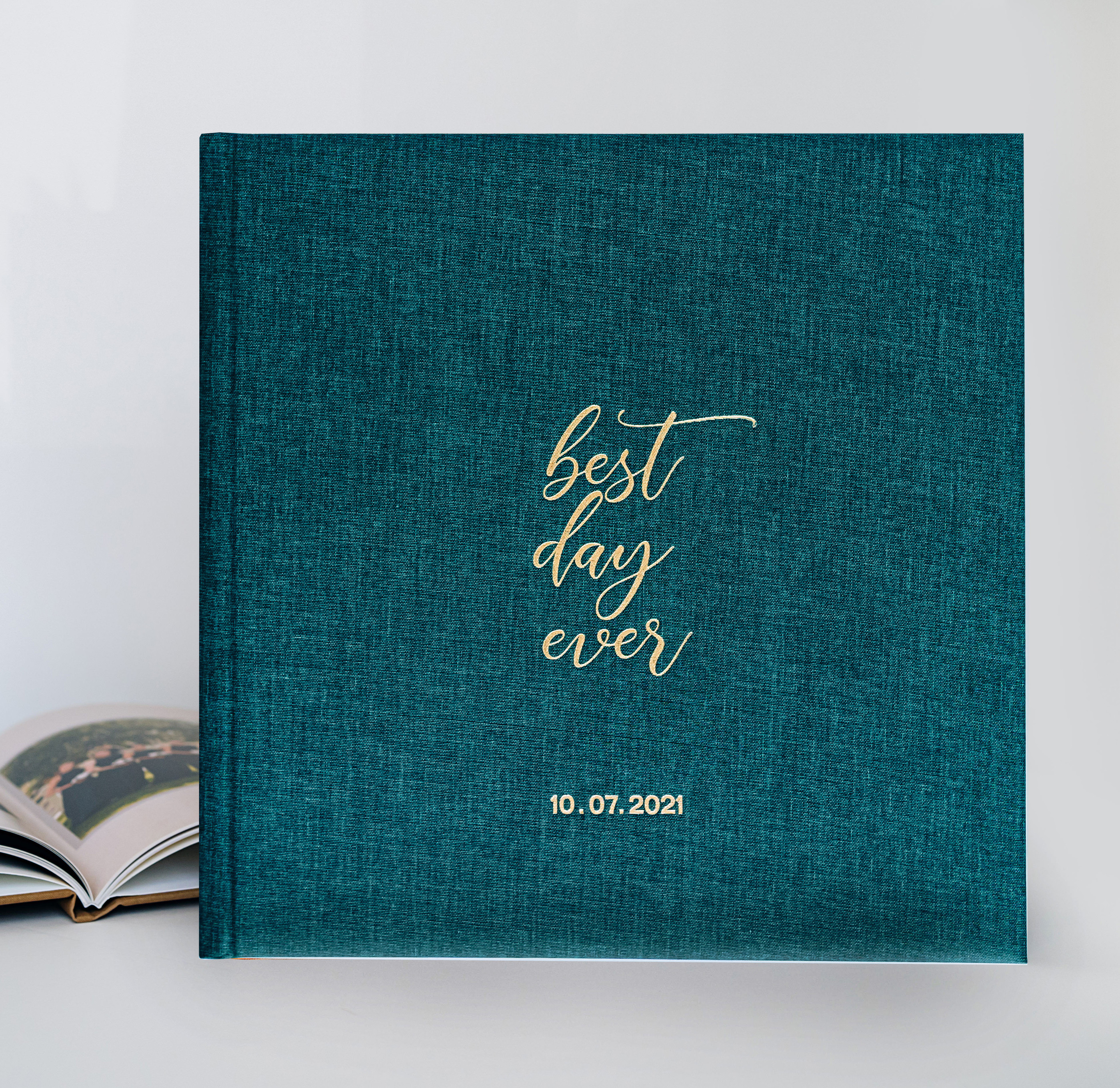 Wedding photo book with green linen cover and gold debossed title