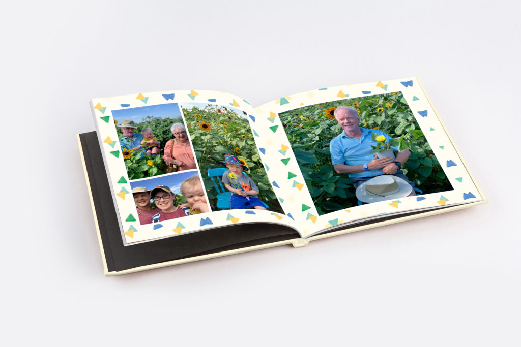 Open baby photo album spread with children and grandparents, styled using PikPerfect’s Celebration layout theme.
