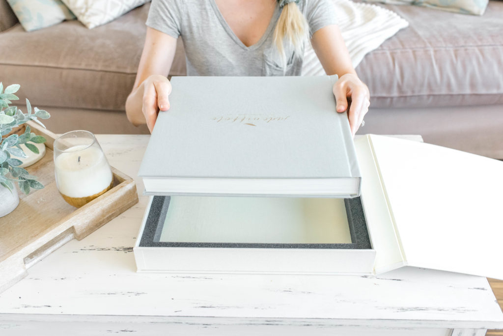 Holding a printed photo book, created through the picture to book process