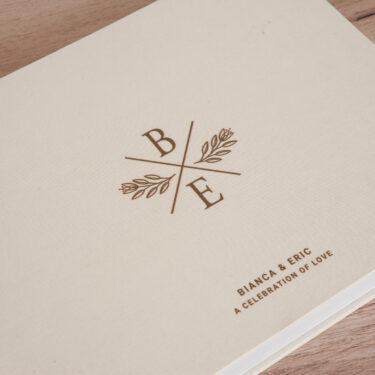 Close-up of UV-printed title on ivory linen wedding album cover.