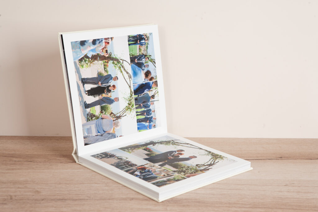 Layflat wedding album open displaying Timeless layout theme with multiple wedding photos arranged in clean grid format on HD Eco Matte pages