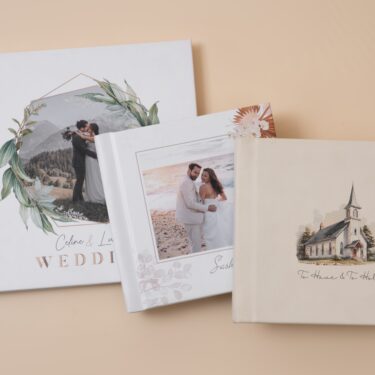 Custom wedding albums with foliage photo cover, spring inspired floral photo cover and cream vegan leather cover with cutsom wedding veneue sketch.