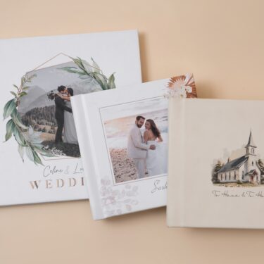 Custom wedding albums with foliage photo cover, spring inspired floral photo cover and cream vegan leather cover with cutsom wedding veneue sketch.